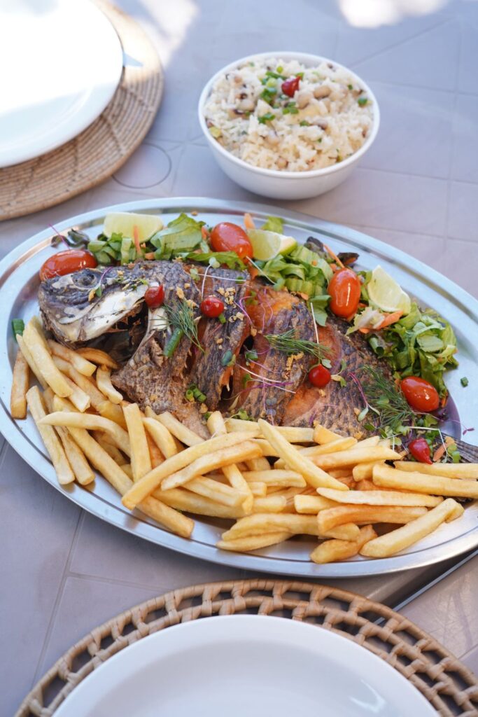 Tilápia frita completa com batata frita, salada e baião de dois na Barraca Atlantidz
